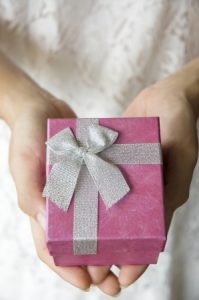 14357536 - woman hands hold pink gift box for giving