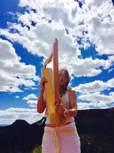 Beth Leone plays wind harp on the mountain top in Sedona Arizona. Harp courtesy of Peter Sterling